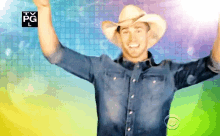 a man in a cowboy hat is dancing in front of a tv pg l logo