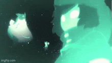 a person is standing in a dark room with a green light coming out of their mouth .