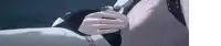 a person is holding a knife in their hand while standing next to a wall .