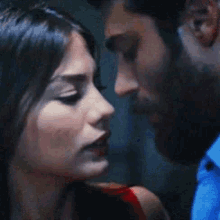 a man and a woman are looking at each other with their eyes closed