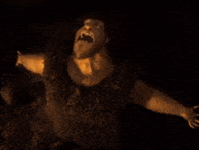 a cartoon character is holding his head in his hands in the dark .