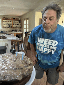 a man wearing a shirt that says " weed makes me happy "