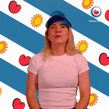 a woman stands in front of a blue and white striped background