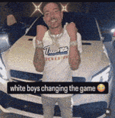 a man standing in front of a white car with the words white boys changing the game below him
