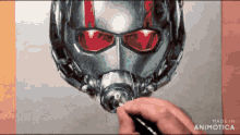 a person is drawing an ant man helmet with a pencil