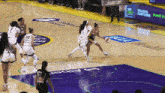 a basketball game is being played on a court that has ucla health written on it