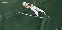 a ski jumper with the word stalinar on his pants is flying through the air