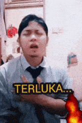a man with his eyes closed and the word terluka written above him