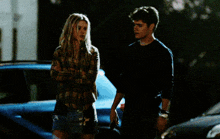 a man and a woman standing next to each other