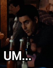 a man sitting at a table with bottles of ketchup and a sign that says um ... no