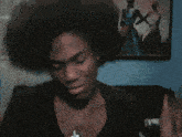 a man with a cross necklace is making a face