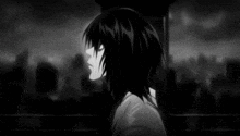 a black and white photo of a boy with long hair standing in front of a city .