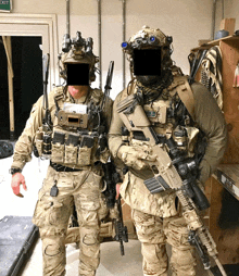two soldiers standing next to each other in front of a green exit sign