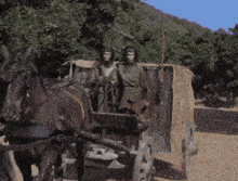 a horse drawn carriage with two people in it .