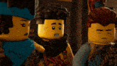 three lego figures are standing next to each other and one has a scarf around his neck