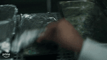 a close up of a person 's hand holding a piece of aluminum foil with the word prime in the corner