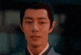a close up of a man 's face with a very serious look on his face .