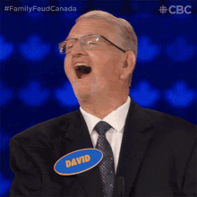 a man wearing glasses and a name tag that says david