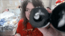 a girl wearing a red shirt that says ' ghost rider ' on it