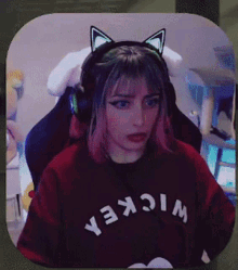 a girl wearing headphones and a shirt that says wickea