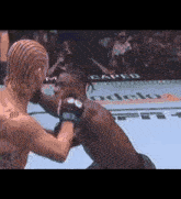 two men are fighting in a boxing ring with a crowd watching
