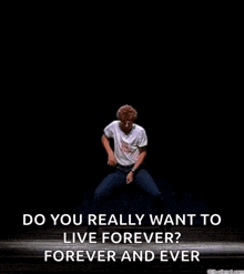 a man is dancing on a stage with the words `` do you really want to live forever ? forever and ever '' written below him .