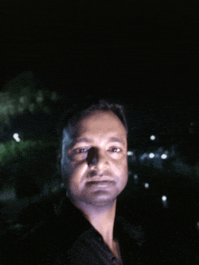 a man is taking a selfie in the dark