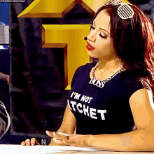 a woman wearing a t-shirt that says boss i 'm not atchet