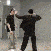 a couple of men are standing next to each other in a room .