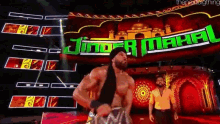 a man is standing in front of a sign that says jinder mahal .