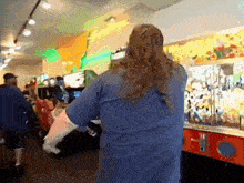 a man in a blue shirt is playing a video game
