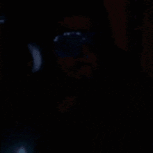 a person is wearing glow in the dark goggles with the number 3 written on them .