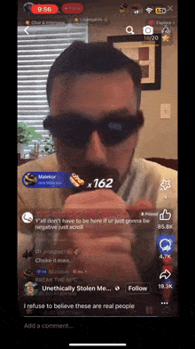 a man wearing sunglasses and a mustache is smoking a cigarette on a phone screen