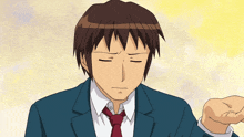 a man in a suit and tie is holding his hand up