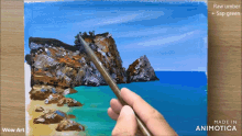 a person is painting a picture of a rocky shoreline with raw umber and sap green
