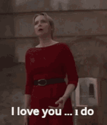 a woman in a red dress is saying i love you