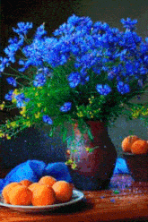 a vase of blue flowers sits on a wooden table next to a plate of apricots