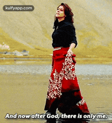 a woman in a long red skirt is standing in the water and says `` and now after god , there is only me . ''