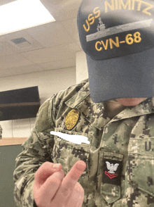 uss nimitz cvn-68 is embroidered on the hat of this soldier