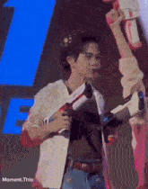 a man is holding a toy gun in front of a blue letter f