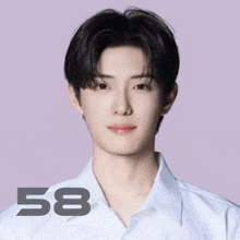 a young man wearing a white shirt has the number 58 on his shirt
