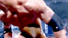 a wrestling match between two men is being shown on a screen .