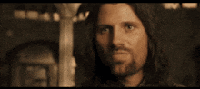 a man with long hair and a beard is sticking out his tongue