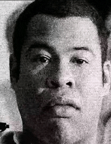 a black and white photo of a man 's face made up of words .