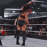 a woman in a wrestling ring with the word iowa on the wall