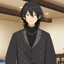 a man with long black hair wearing a black turtleneck and a black jacket