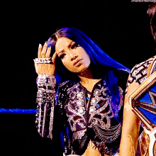 a woman wearing a ring that says boss on it