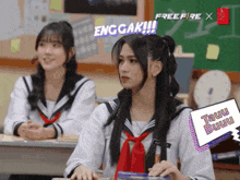 two girls in school uniforms are sitting in a classroom with a free fire x logo behind them