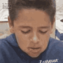 a young boy is making a funny face with his eyes closed and his mouth open .