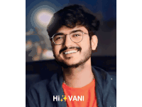 a man wearing glasses and a red shirt with the name hi vani on the bottom